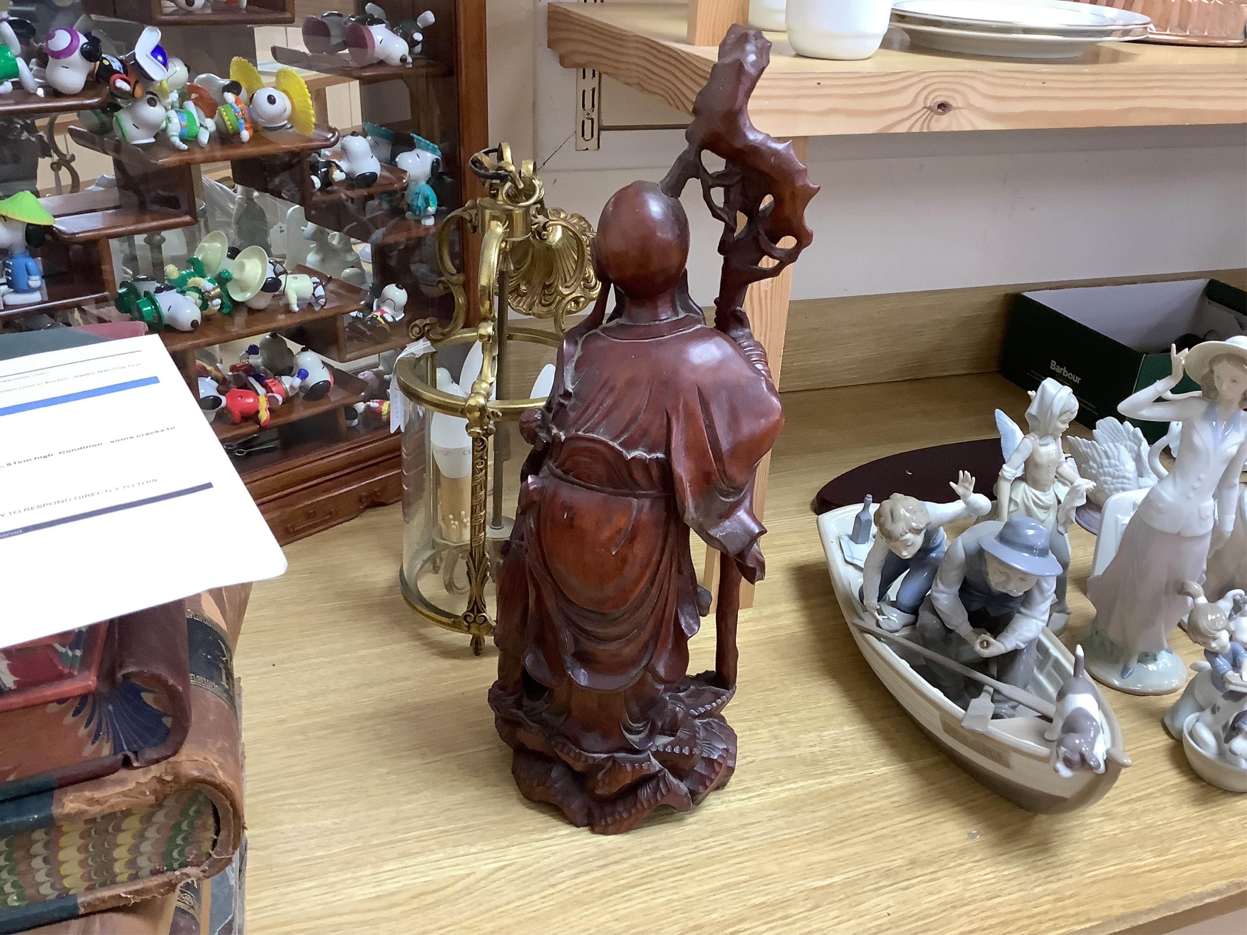 A large Chinese carved wood figure of Shouloau, 51cm high. Condition - some cracks to the wood